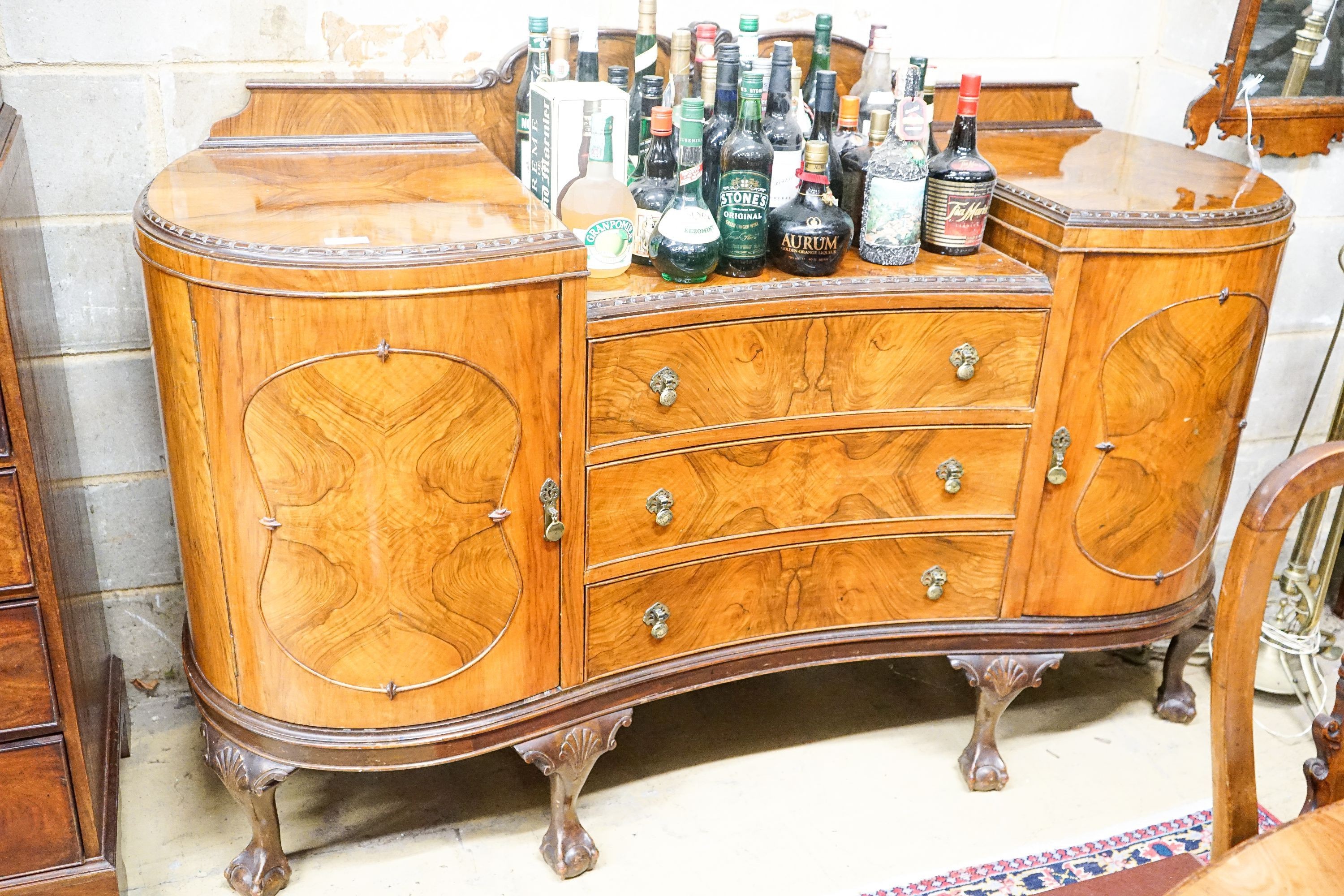 A Queen Anne style figured walnut dining suite comprising extending dining table, 200cm extended (one spare leaf), width 104cm, height 76cm, six chairs (two with arms) and a concave fronted sideboard